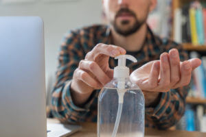 man using hand sanitizer