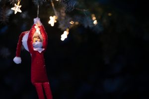 Christmas toy hangs on a glowing garland